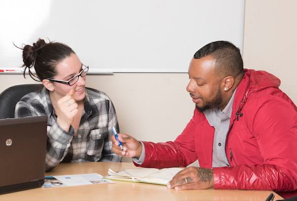 Two people talking at a table