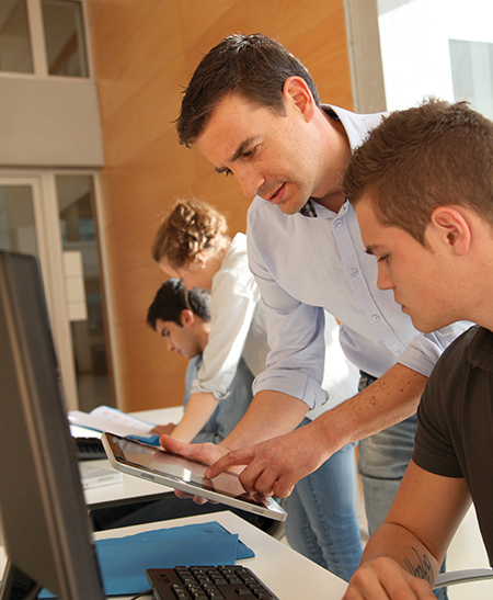 Male helping male on computer