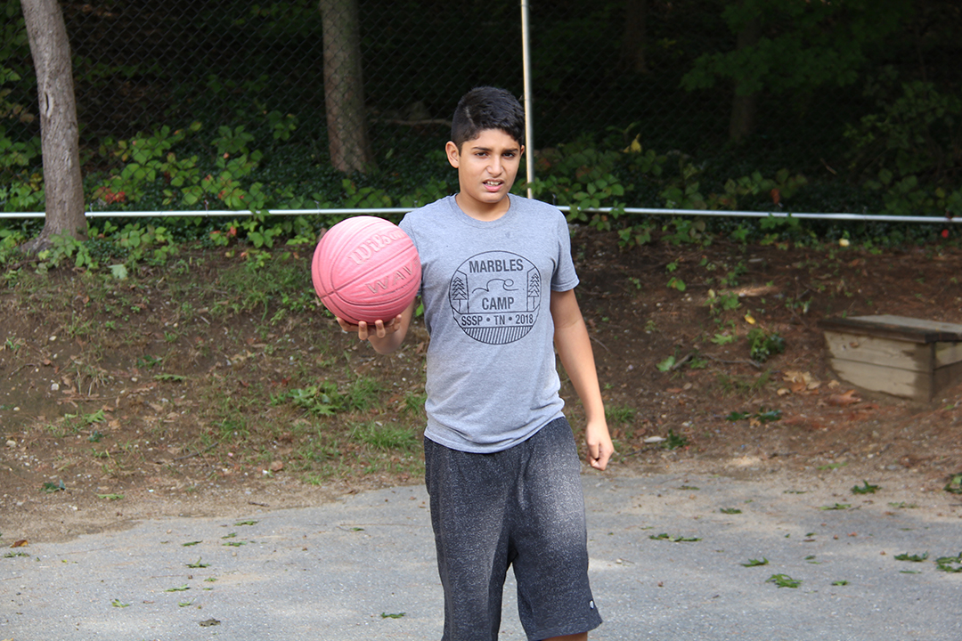 Child Playing Basketball