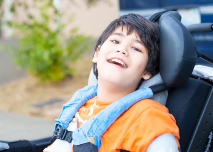 smiling boy in wheel chair